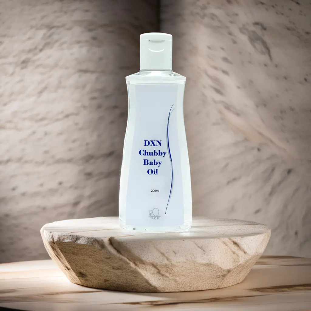 A bottle of DXN Chubby Baby Oil placed beside a baby towel and teddy bear, ideal for natural baby skincare